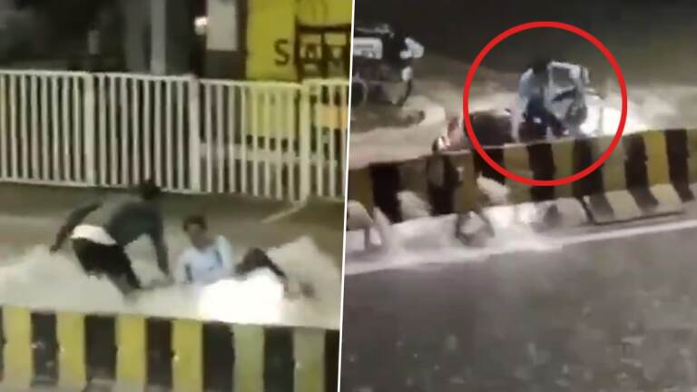 Biker Washed Away In Flood: வெள்ளத்தில் அடித்துச் செல்லப்பட்ட இருசக்கர வாகன ஓட்டி.. காப்பாற்றிய பொதுமக்கள்.. வைரலாகும் வீடியோ..!